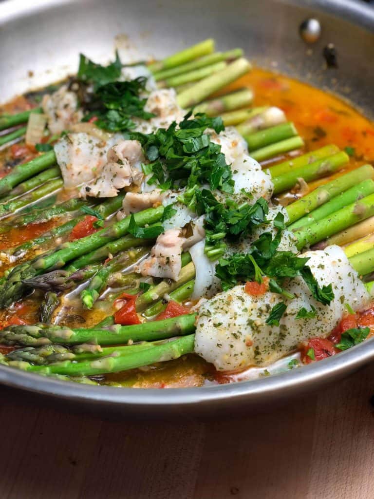 dover sole and asparagus poached in lemon butter tomato sauce