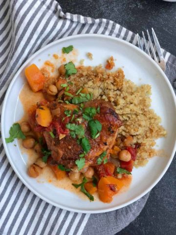 morrocan chicken quinoa butternut squash cilantro garnish in white plate