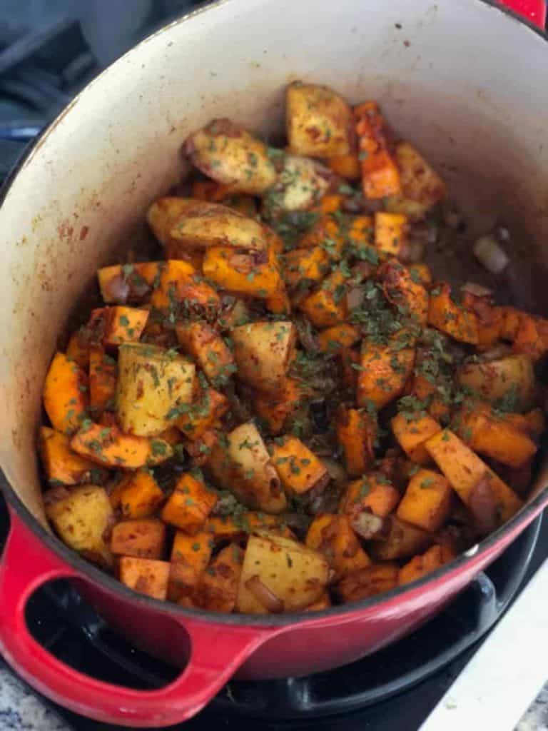 cubes of potatoes and butternut squash mixed with spices