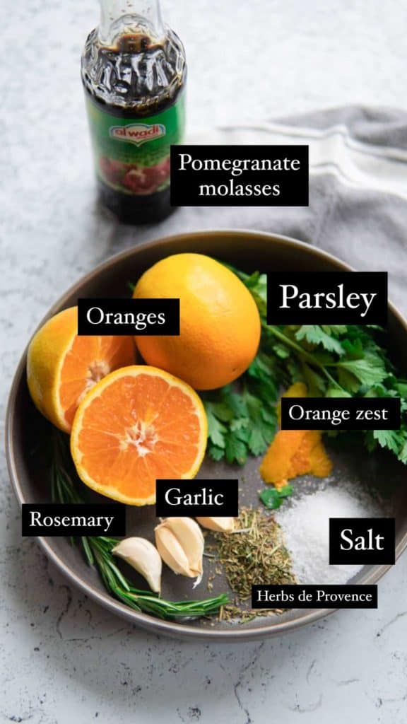 plate with oranges, garlic and herbs