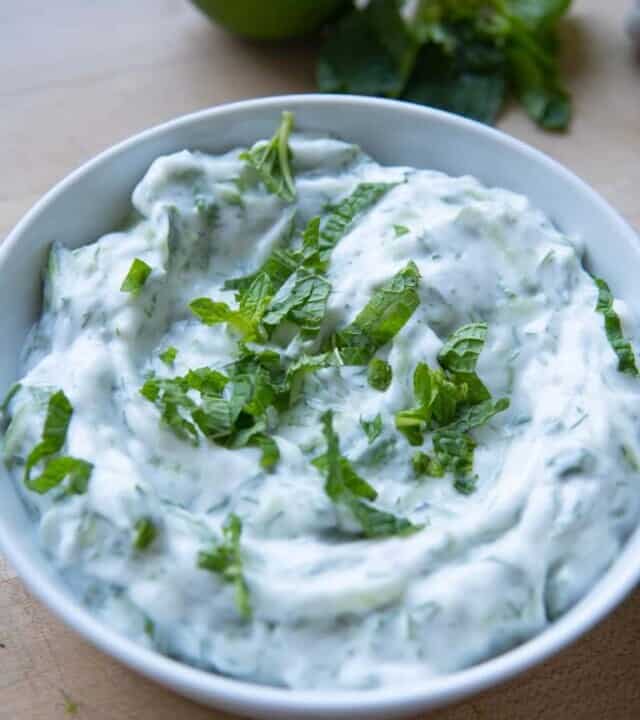 vegan tzatziki sauce in bowl with mint on top