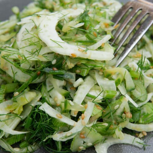 close up of shaved fennel, stalks and fronds, mixed with sesame seeds