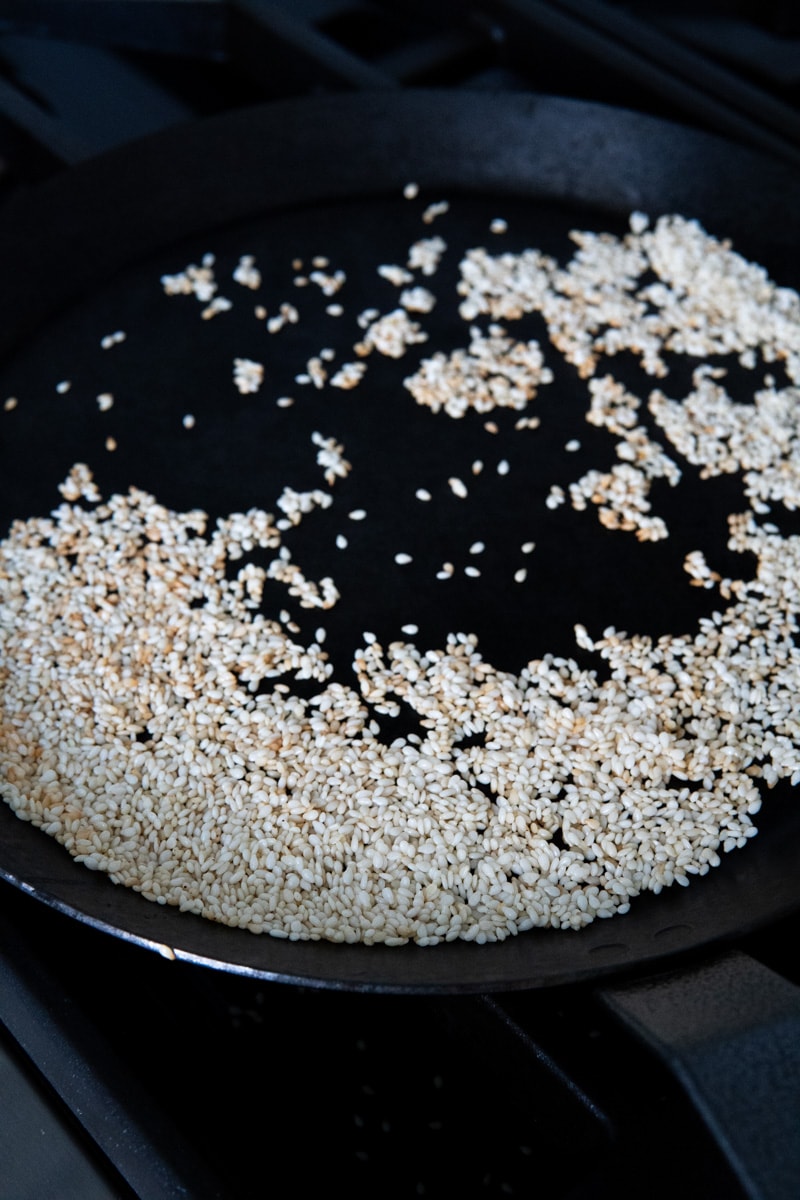 toasting sesame seeds in a cast iron skillet.