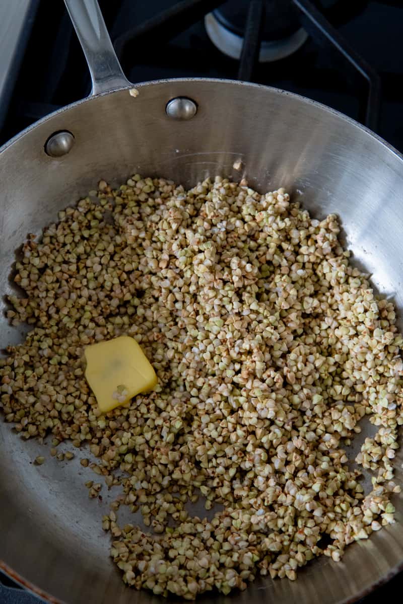 Toasting buckwheat groats in a pan with butter.