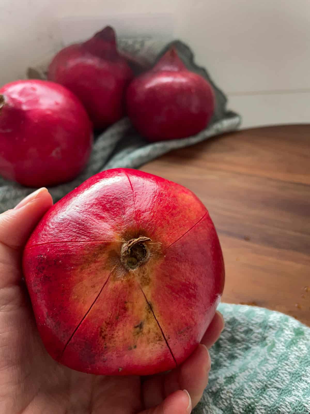 A pomegranate with 5 cuts made along the outside.