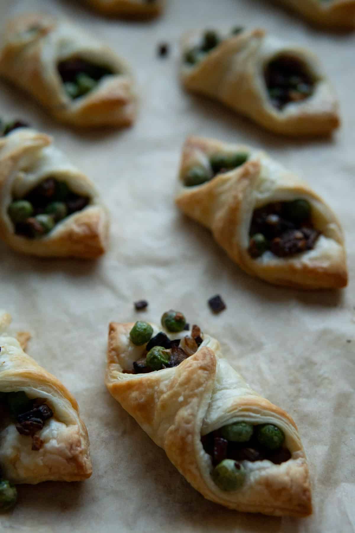 Baked puff pastry bites on a baking sheet.