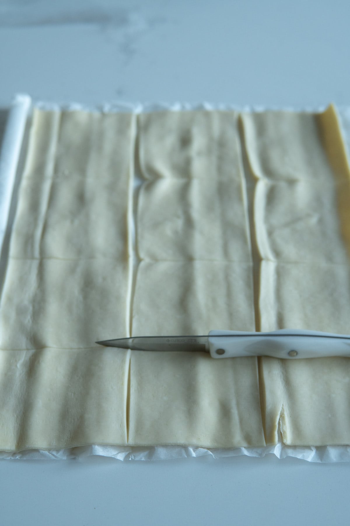 Rolled out puff pastry cut into squares.