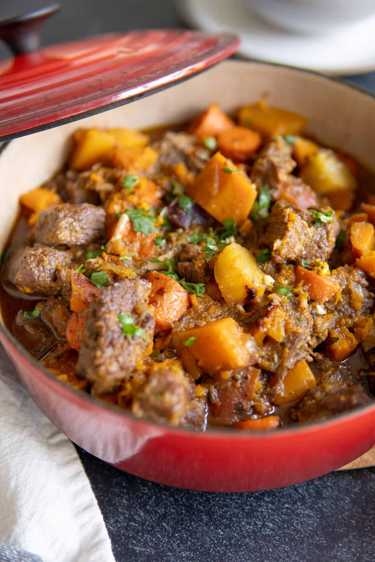 braised beef stew in dutch oven with butternut squash and chunky carrots 