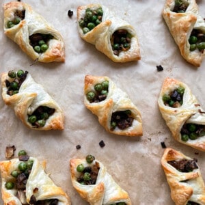 tray of puff pastry bites with peas and mushrooms