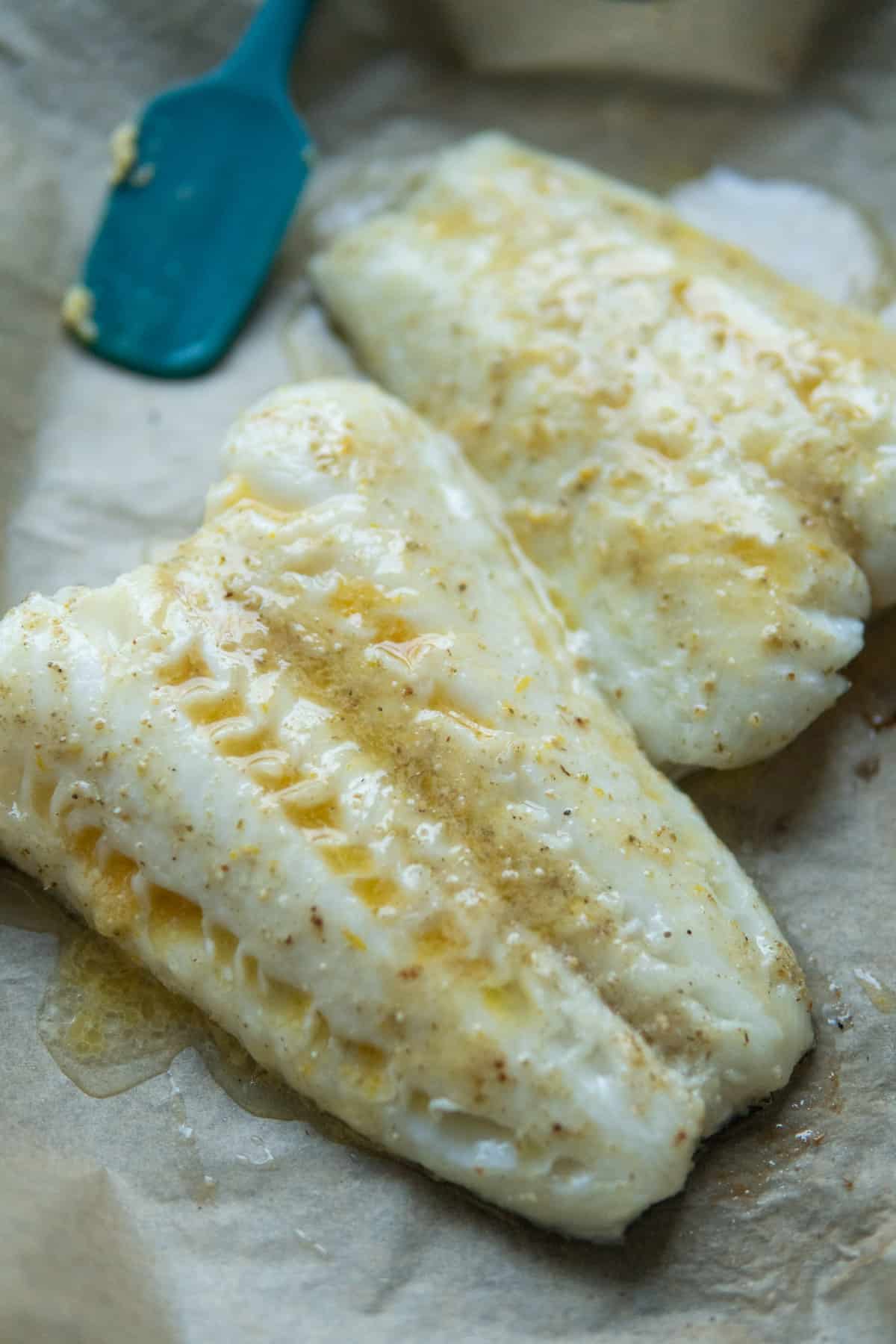fish fillets with melted miso butter and spatula on side 