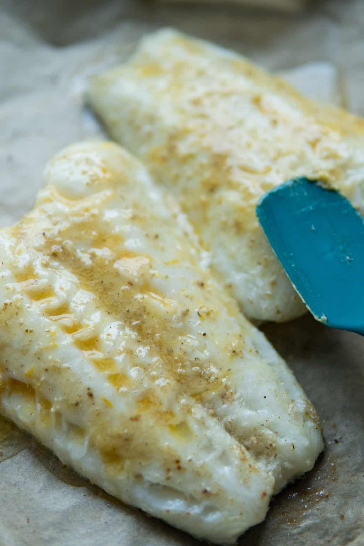 fish fillet with miso butter melted and spread with spatula 