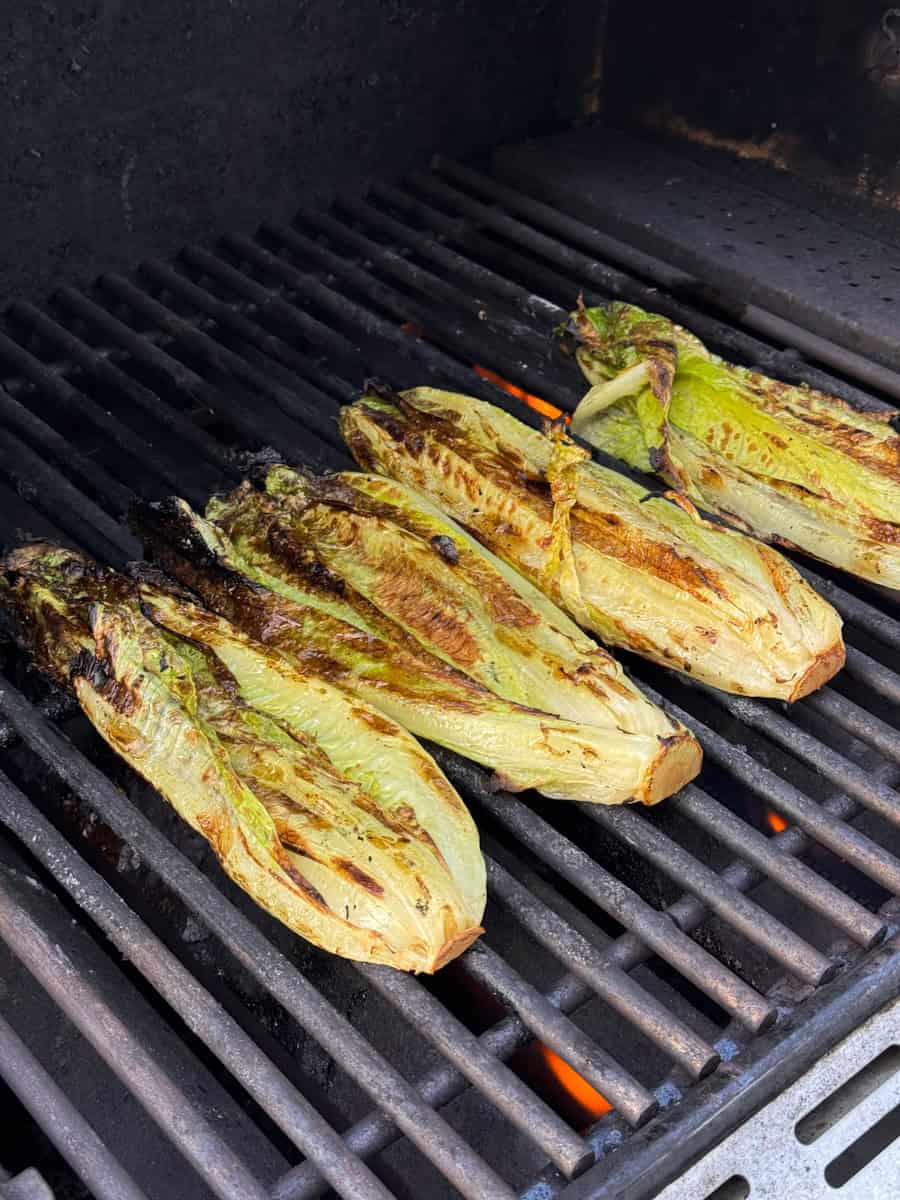 romaine lettuce with char marks cooking on grill