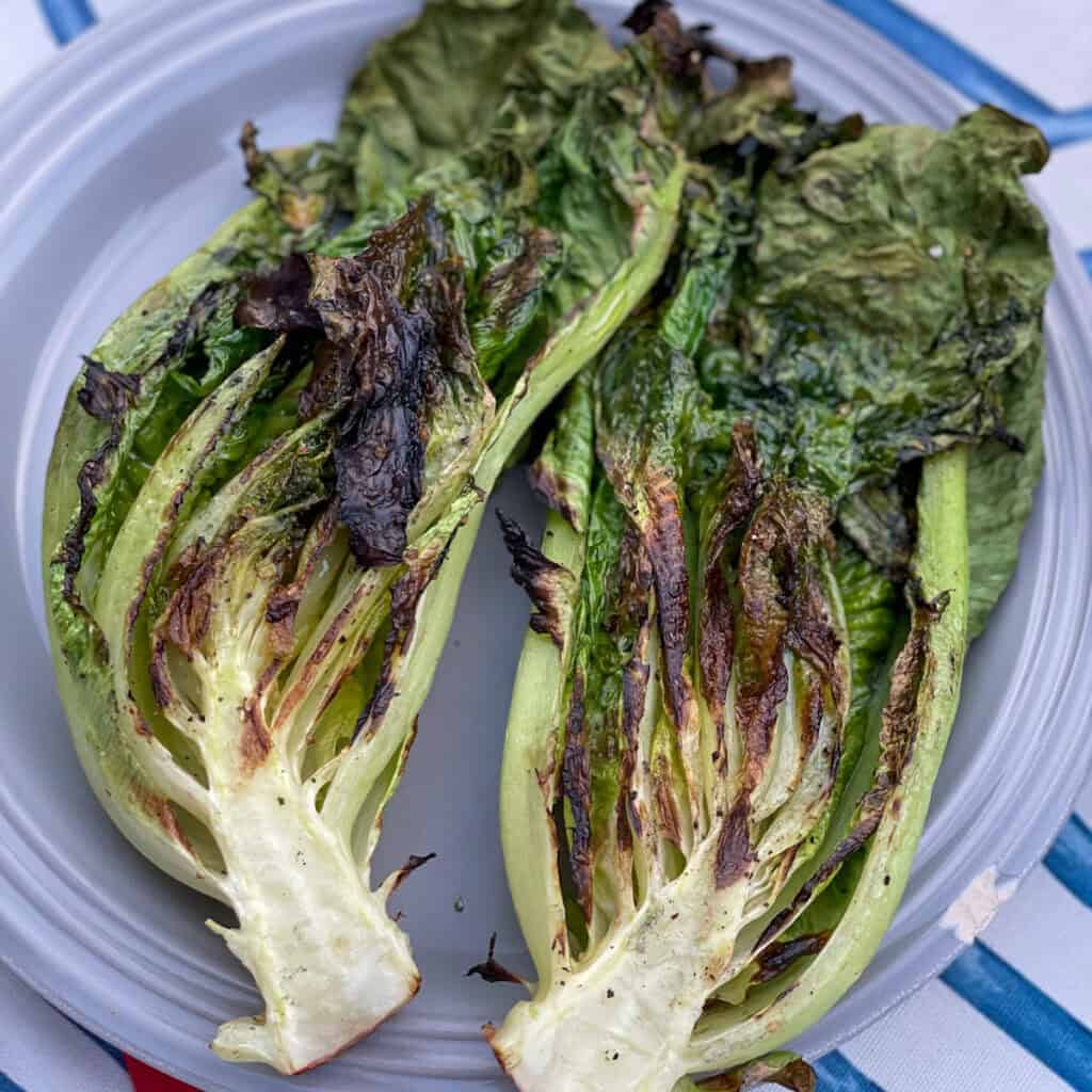 romaine cut in half, grilled, on a plate 