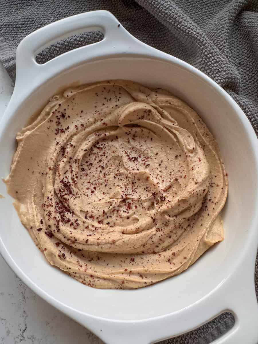 white bowl with hummus and sumac 