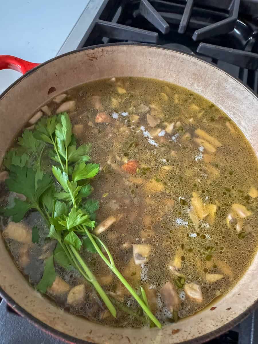 dutch oven with mushrooms and liquid to make soup. 