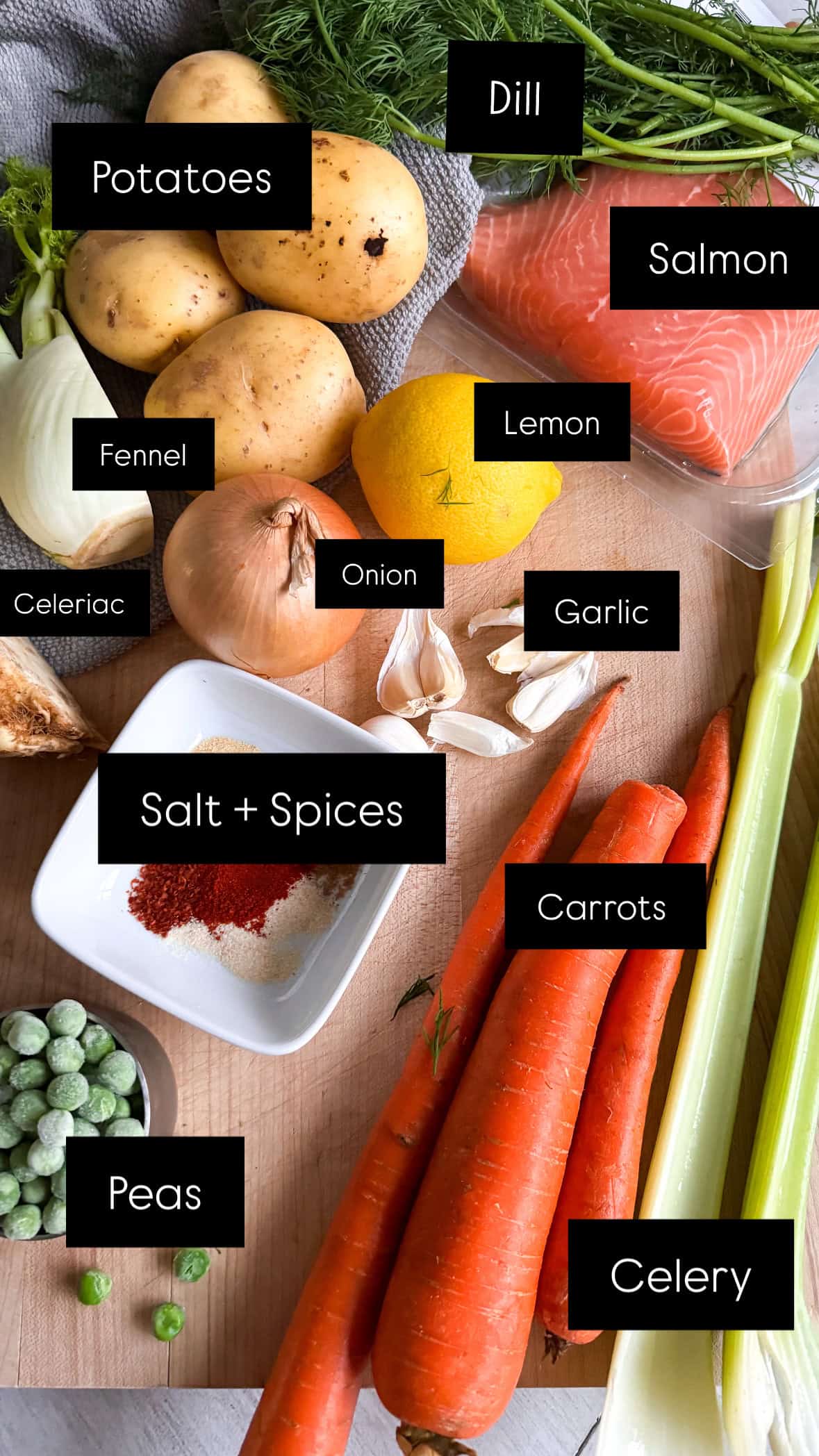 assortment of vegetables, spices and salmon on a cutting board. 