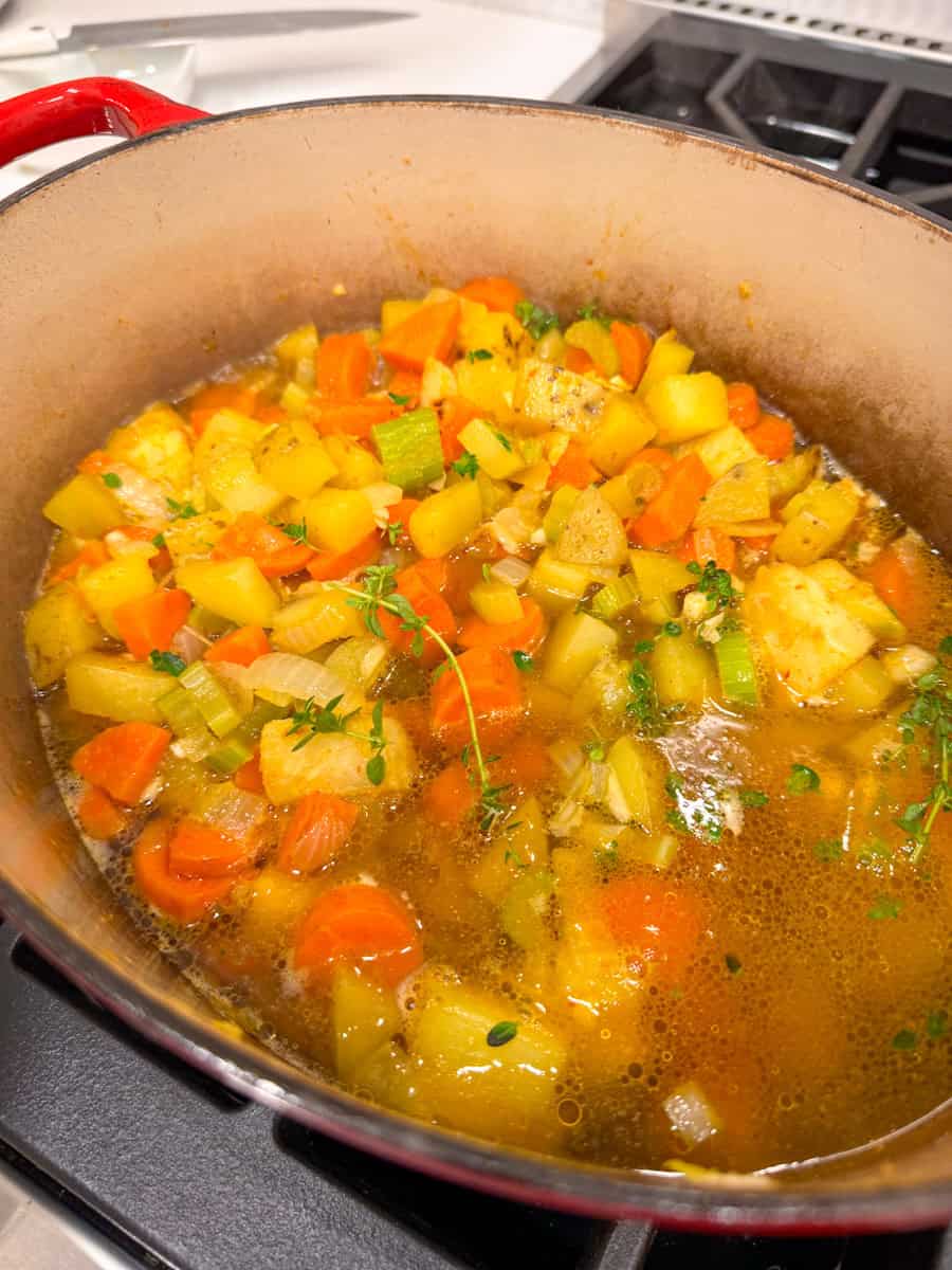 dutch oven with vegetables and broth 