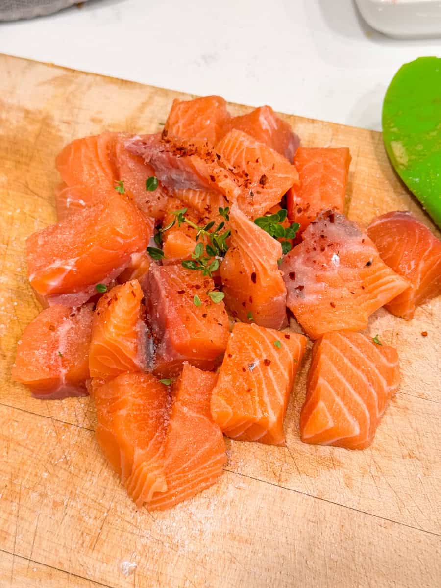 salmon cut up into cubes with spices 