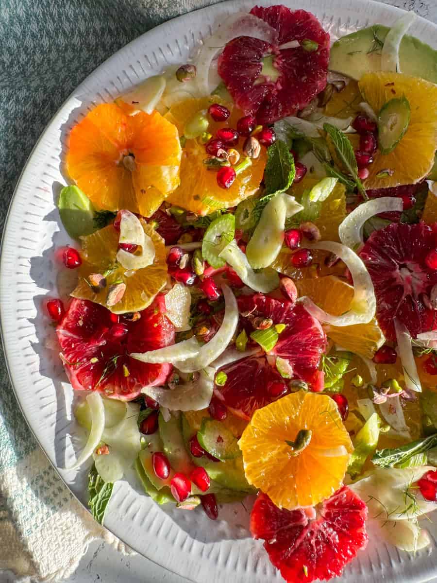 close up of different color oranges, slices of fennel and mint 