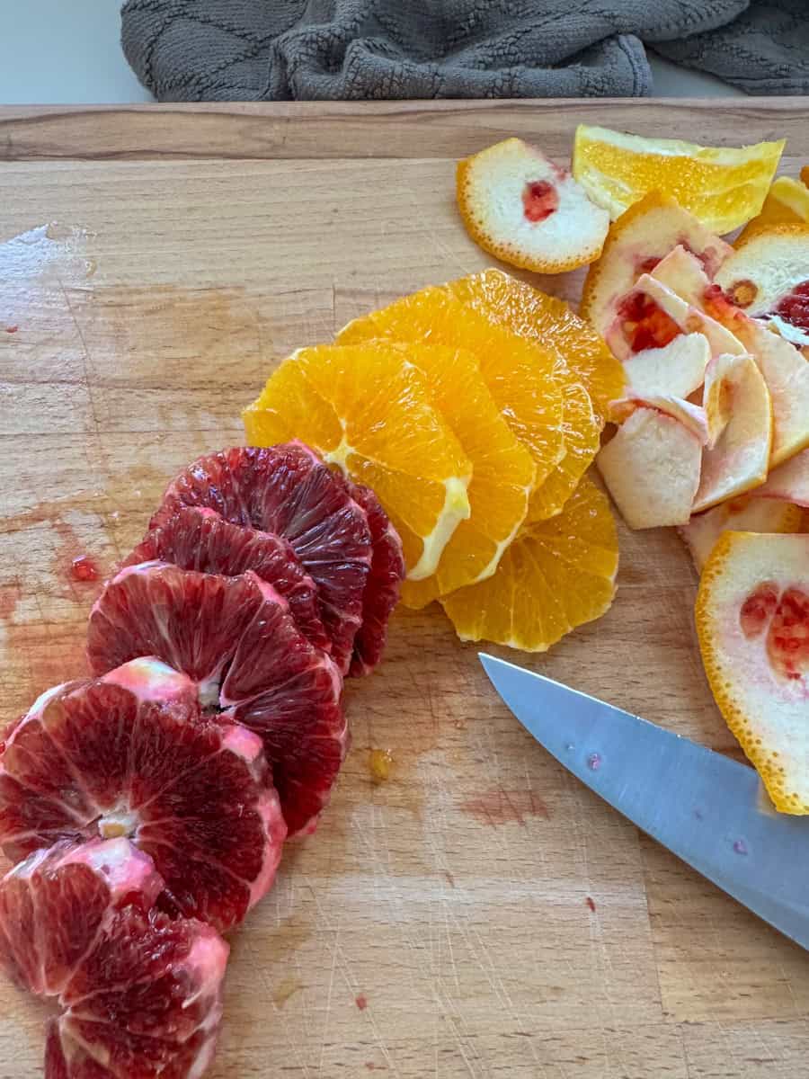 rounds of different color oranges cut up 