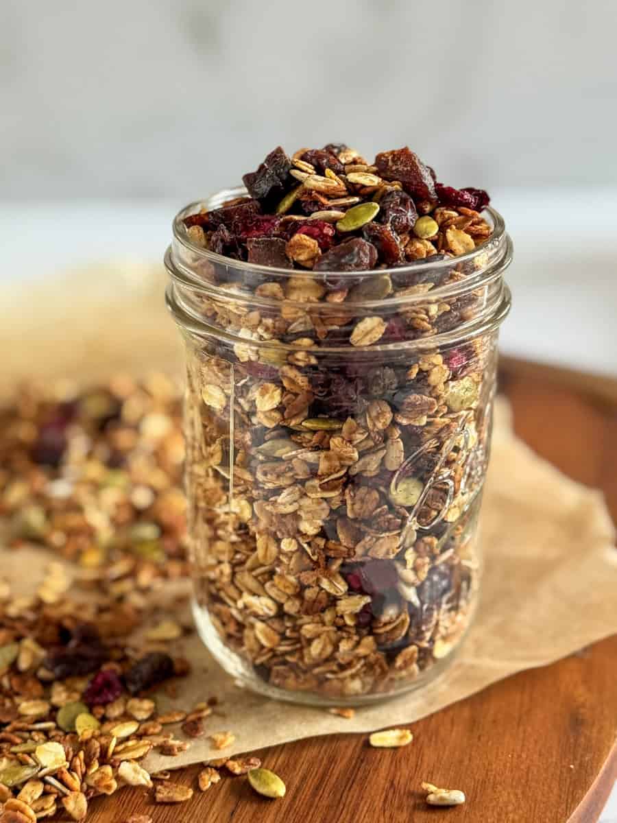 jar filled with nut free granola , overflowing. 