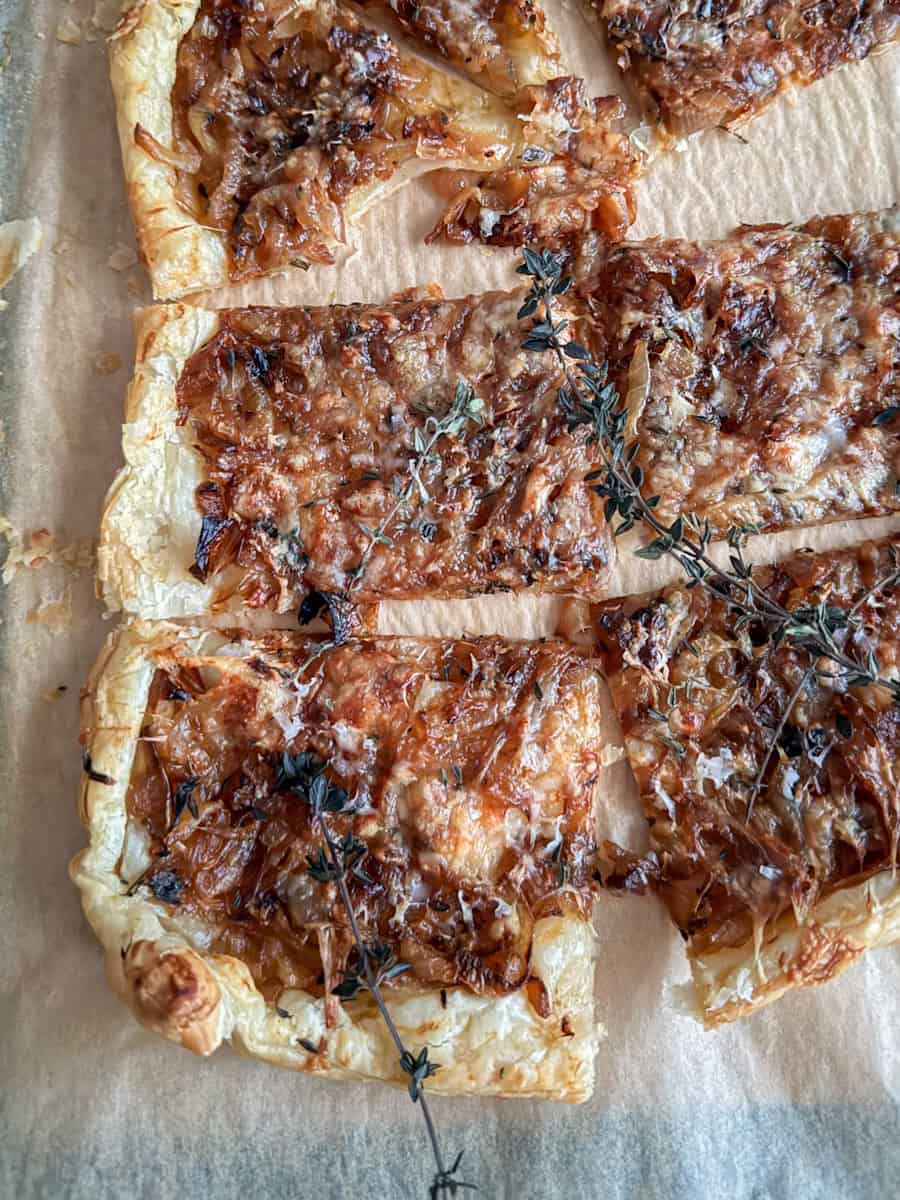 puff pastry with caramelized onion cut up into squares.