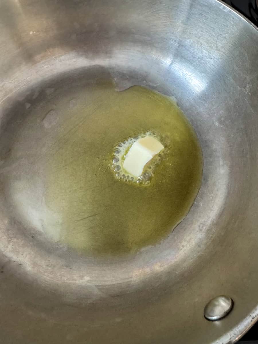 stainless steel pan with oil and butter melting
