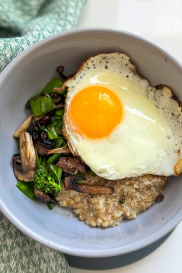 bowl with steel cut oats, vegetables and jammy egg.